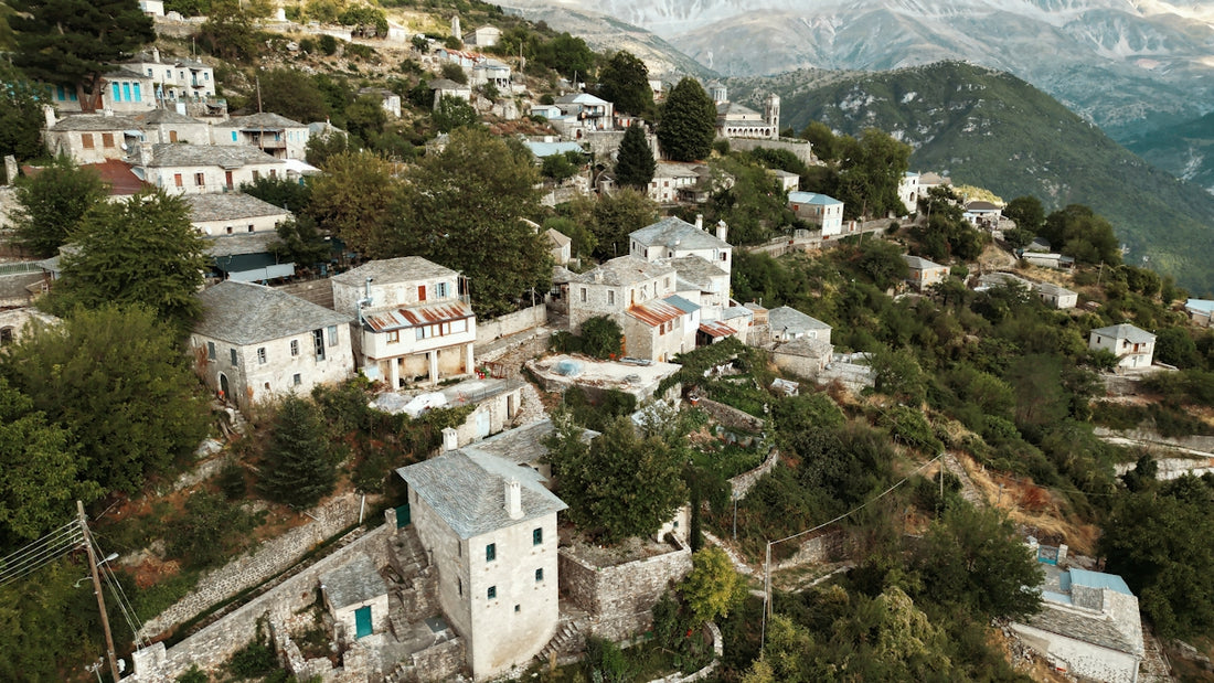 Traditional village nestled on a steep, green mountainside.